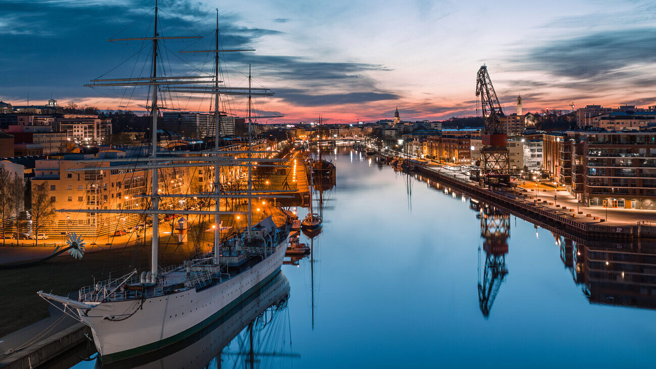 Aerial view of calm aurojoki river and Swan of Finland sailing ship at dawn in Turku, Finland