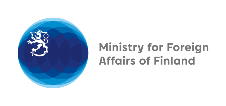 Logo of the Ministry for Foreign Affairs of Finland. The logo features a blue circular emblem with the Finnish lion at its center, alongside the text “Ministry for Foreign Affairs of Finland” in grey.